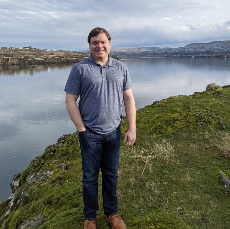 Meadow Outdoor Advertising Salesperson Todd Rogers standing in front of Columbia River